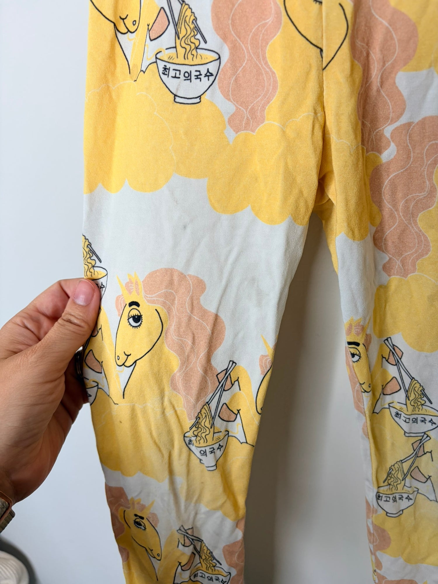 Multicoloured kids sleepwear set with various graphic designs including mermaids, cacti, and whimsical creatures.