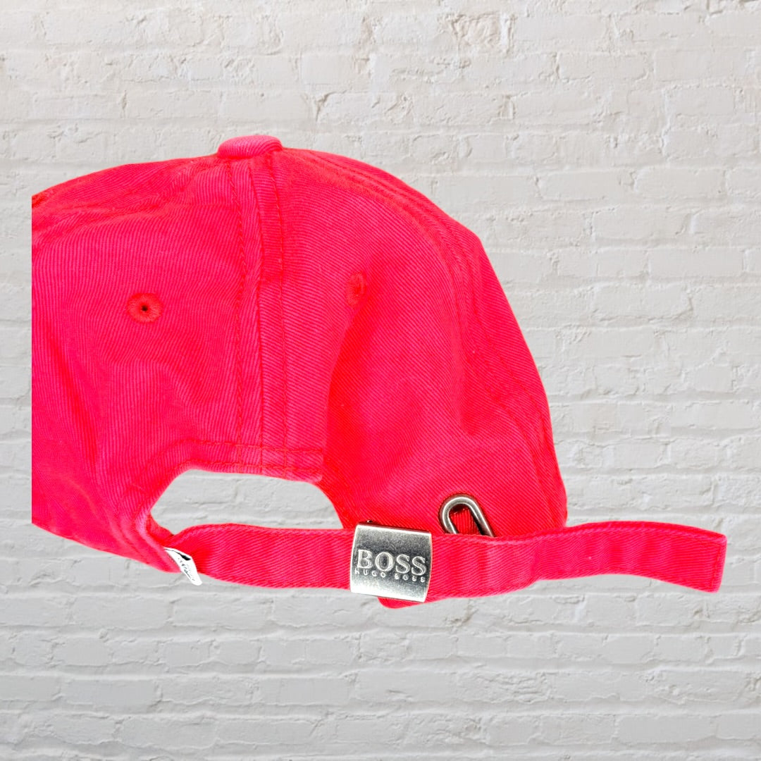 Red Hugo Boss baseball cap with black logo, featuring an adjustable strap.