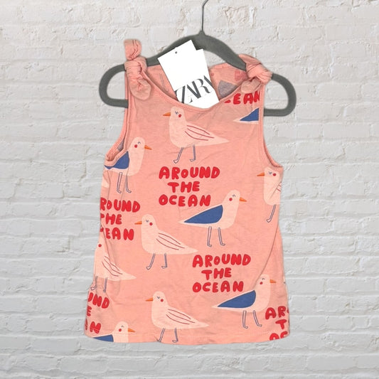 Peach tank top with bird and 'Around the Ocean' print, featuring knotted straps, with Zara tags attached.