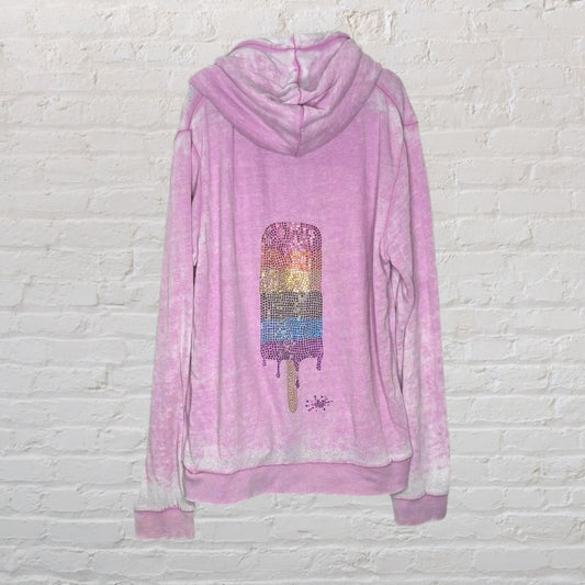 Pink hoodie with a sequined rainbow popsicle design on the back.