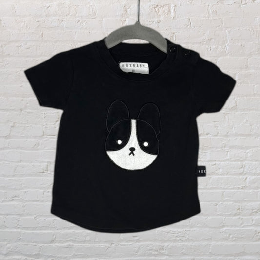 Black Huxbaby short-sleeve T-shirt for kids featuring a cute puppy face applique on the front.