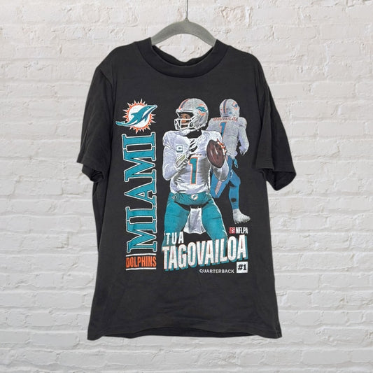 Black Miami Dolphins T-shirt featuring a graphic of Tua Tagovailoa in uniform with team branding.