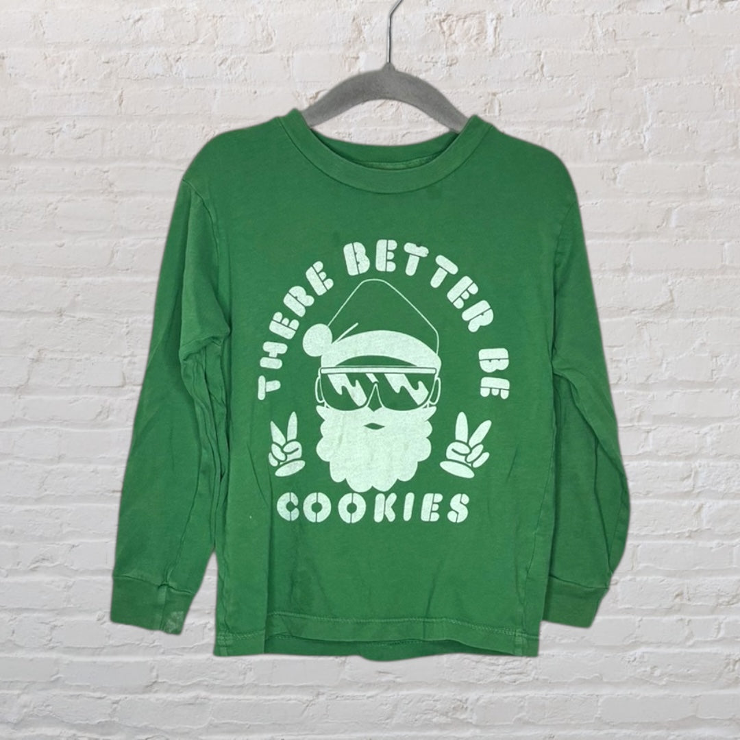 Green long-sleeve T-shirt with a Santa graphic and 'There Better Be Cookies' text, hanging on a hanger.