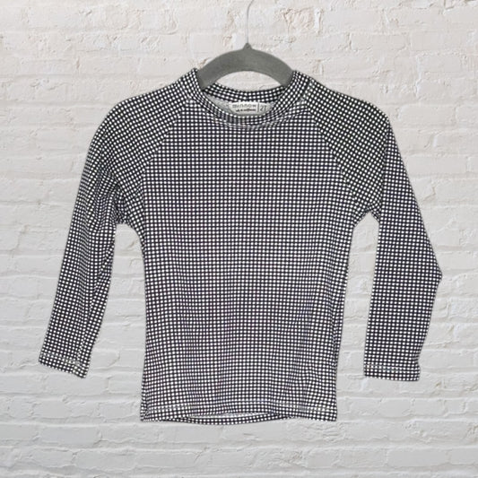 Black and white checkered long sleeve top by Minnow, size 2T, hanging on a gray hanger.