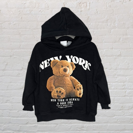 Black hoodie with teddy bear graphic and 'New York' text, suitable for unisex wear.