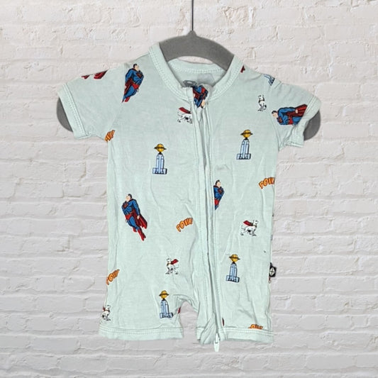 Light blue baby romper with Superman graphics and a zip closure, displayed on a hanger.