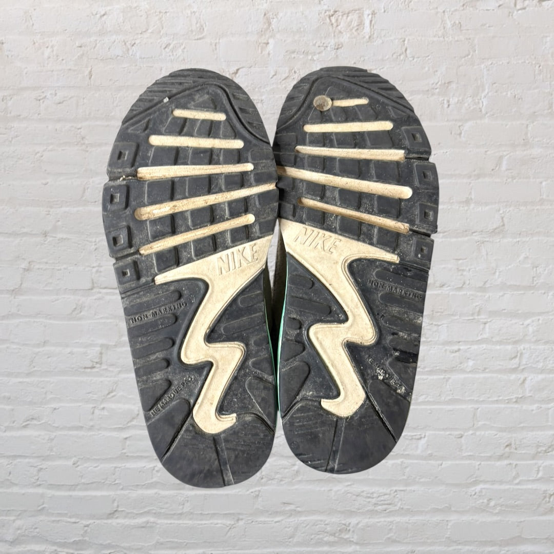 White sneakers with navy, red, and mint green accents, featuring a classic design with laces.