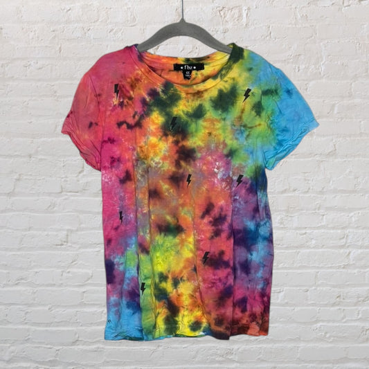 Multicolored tie-dye T-shirt with black lightning bolt print, hanging on a hanger.