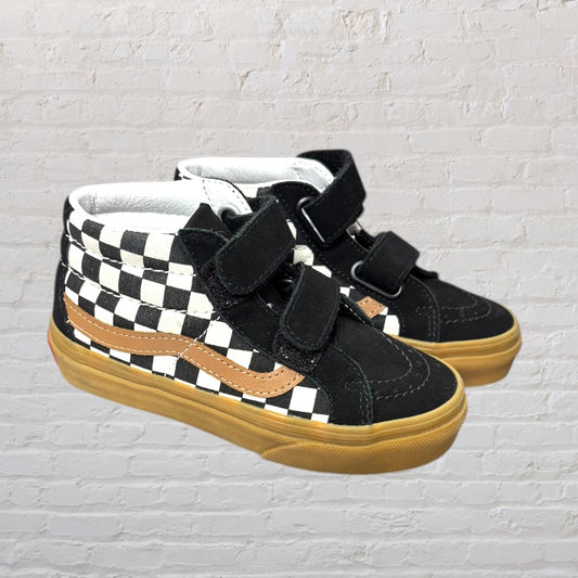 Pair of high-top sneakers with a black and white checkered pattern, brown detailing, and velcro straps.