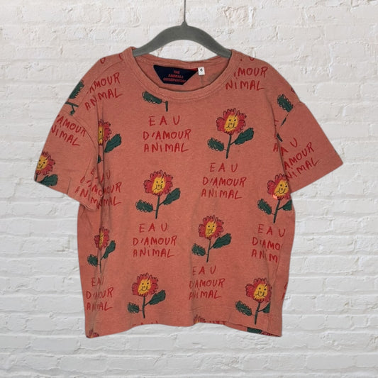 Rust-colored T-shirt with flower graphics and 'Eau D'amour Animal' text printed all over, by The Animals Observatory.