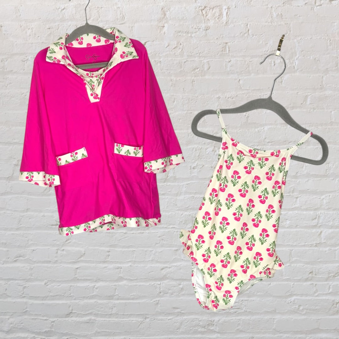 Pink floral swim cover-up and matching swimsuit set with green floral accents on hangers.