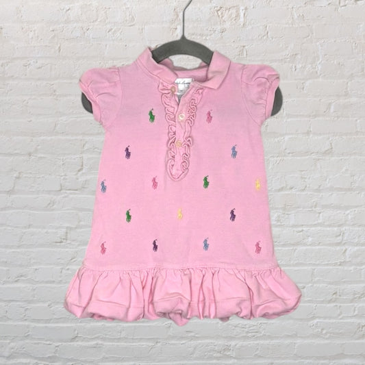 Pink ruffle polo dress with multicolored embroidered logos, featuring a frilly collar and hem.