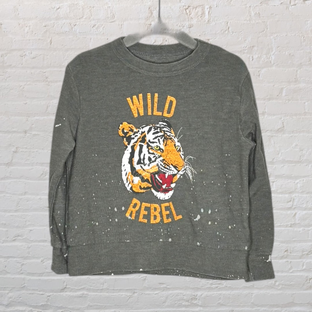 Olive green sweatshirt featuring a 'Wild Rebel' text and tiger graphic, with paint splatter details.