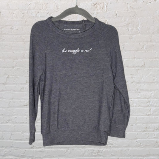 Charcoal gray sweatshirt with 'The Snuggle Is Real' text, by good hYOUman, hanging on a hanger.