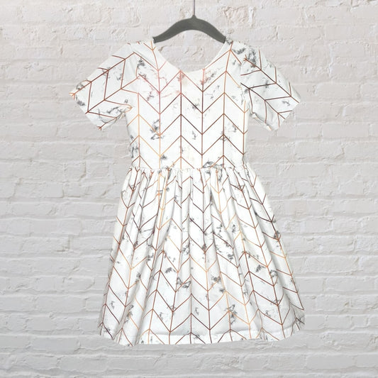 White dress with a geometric floral pattern in brown and grey, short sleeves, and pleated skirt.