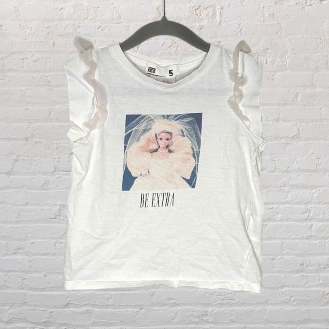 White children's tee with ruffle sleeves and a graphic print of a doll with 'Be Extra' text.