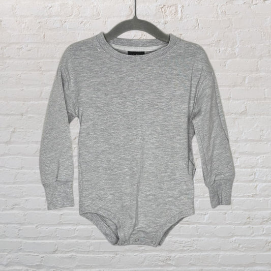 Grey long sleeve baby bodysuit with snaps at the bottom, hanging on a hanger.