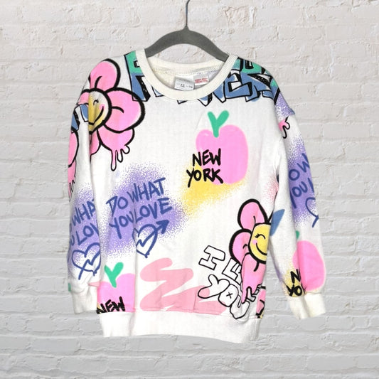 Colourful graffiti art sweatshirt featuring flowers, hearts, and New York themed text.