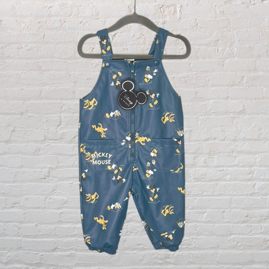 Blue Disney Mickey Mouse rain overalls with yellow cartoon graphics, new with tags, hanging on a hanger.