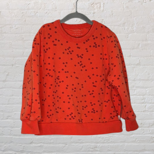 Red sweatshirt with black floral pattern, featuring long sleeves and a round neckline, by Bonton.