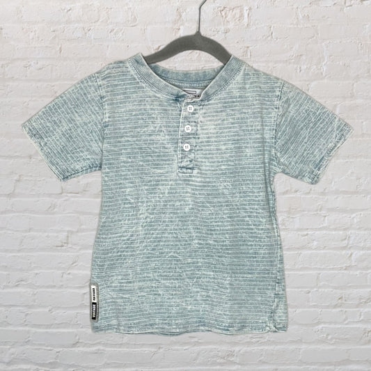 Light blue striped Henley T-shirt with a three-button placket, displayed on a hanger.