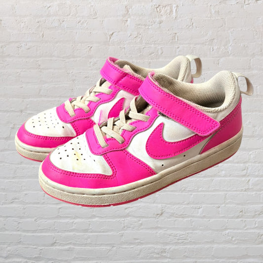 Pair of pink and white sneakers with Velcro straps and laces, showing some wear.