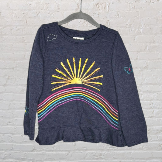 Navy blue long-sleeve top with a sun and rainbow graphic, featuring small cloud and butterfly accents.