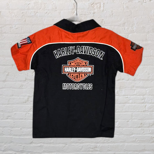 Black and orange Harley-Davidson shirt with embroidered logos and graphics, featuring short sleeves.