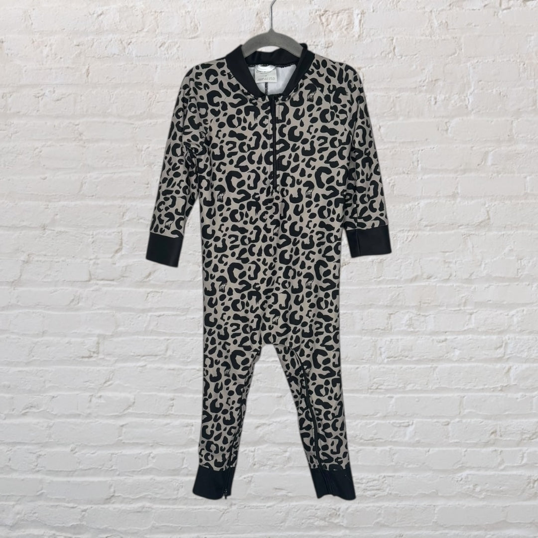 Unisex baby onesie with a gray and black leopard print, featuring black cuffs and a zipper.
