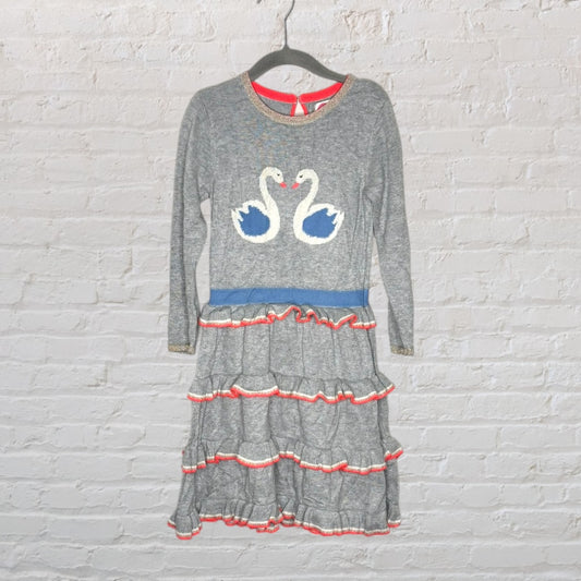 Grey long-sleeve dress with swan appliqué and layered skirt with red and white ruffles.