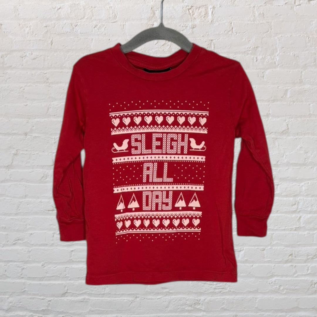 Red sweater with white festive 'Sleigh All Day' print and holiday motifs, displayed on a hanger.