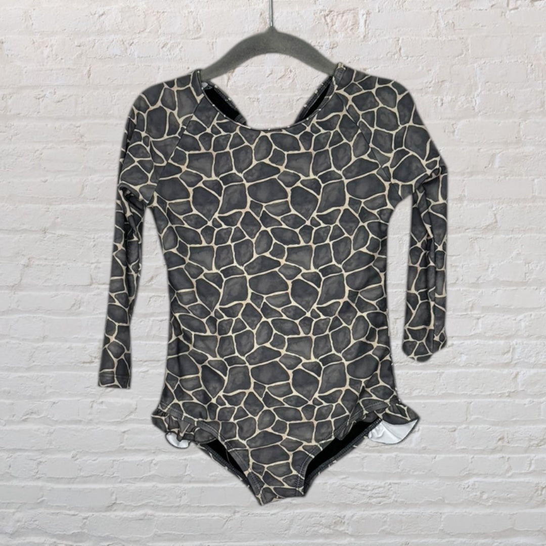 Long sleeve giraffe print bodysuit in black and beige hanging on a hanger.