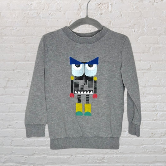 Grey sweatshirt with a colorful geometric robot graphic in the center, displayed on a hanger.
