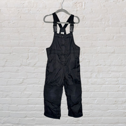 Children's black snow bib overalls with adjustable straps hanging on a hanger.