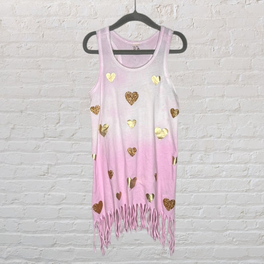 Pink tank top with gold heart designs and fringe hem, hanging on a hanger.