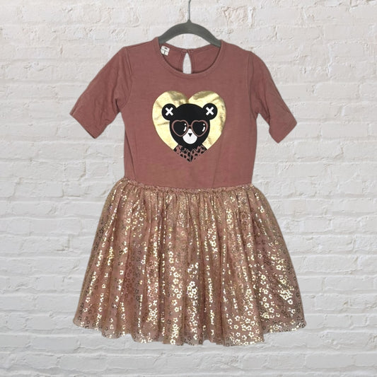 Dusty pink dress with a bear heart graphic on the top and a gold sequin skirt.
