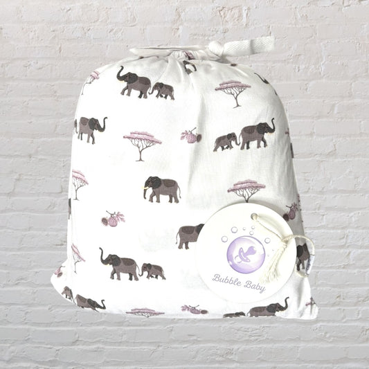 White baby swaddle blanket with a print of elephants and trees, packaged with a Bubble Baby tag.