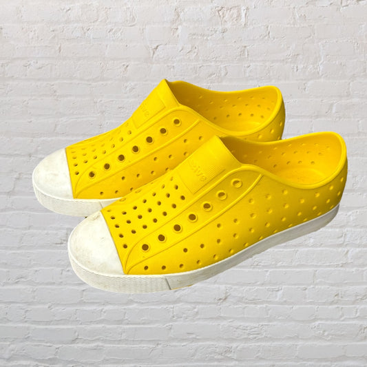 Bright yellow perforated slip-on shoes with white soles, perfect for casual wear.