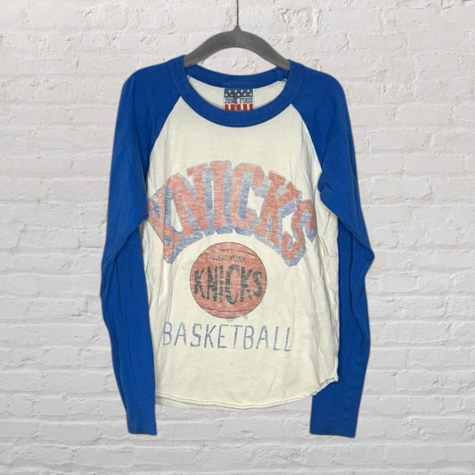 Cream raglan tee with blue sleeves featuring the New York Knicks basketball logo and text, by Junk Food.