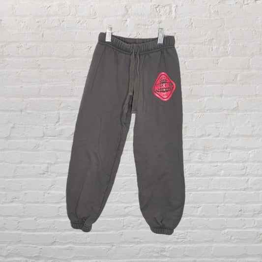 Grey sweatpants by Muskoka Bear Wear with pink logo, featuring an elastic waistband and cuffs.