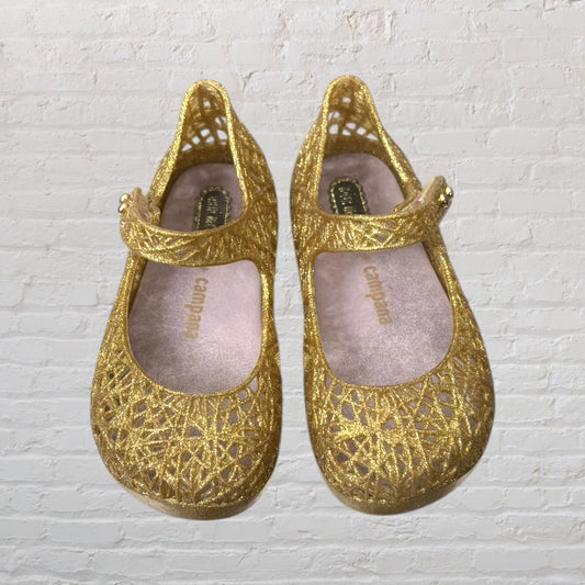 Pair of glittery gold Mary Jane shoes with a delicate lattice design and strap, from Campana.