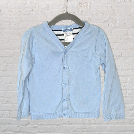 Light blue button-up cardigan for toddlers with ribbed cuffs and hem, hung on a hanger.