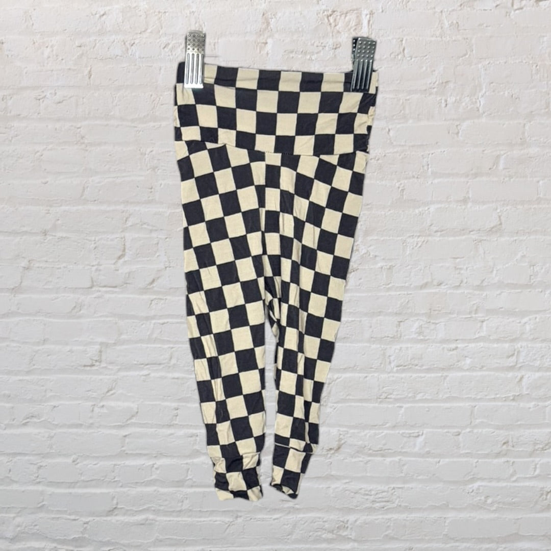 Black and cream checkered long sleeve pajama set with a henley neckline, hanging on a hanger.