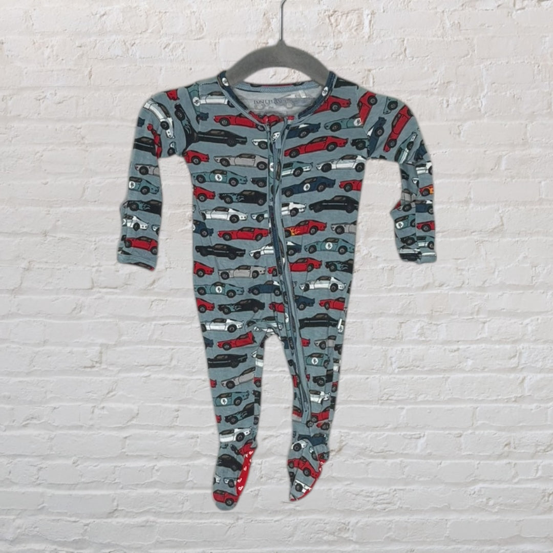Grey baby onesie with a car pattern in red, black, and white, featuring a front zipper, hanging on a hanger.