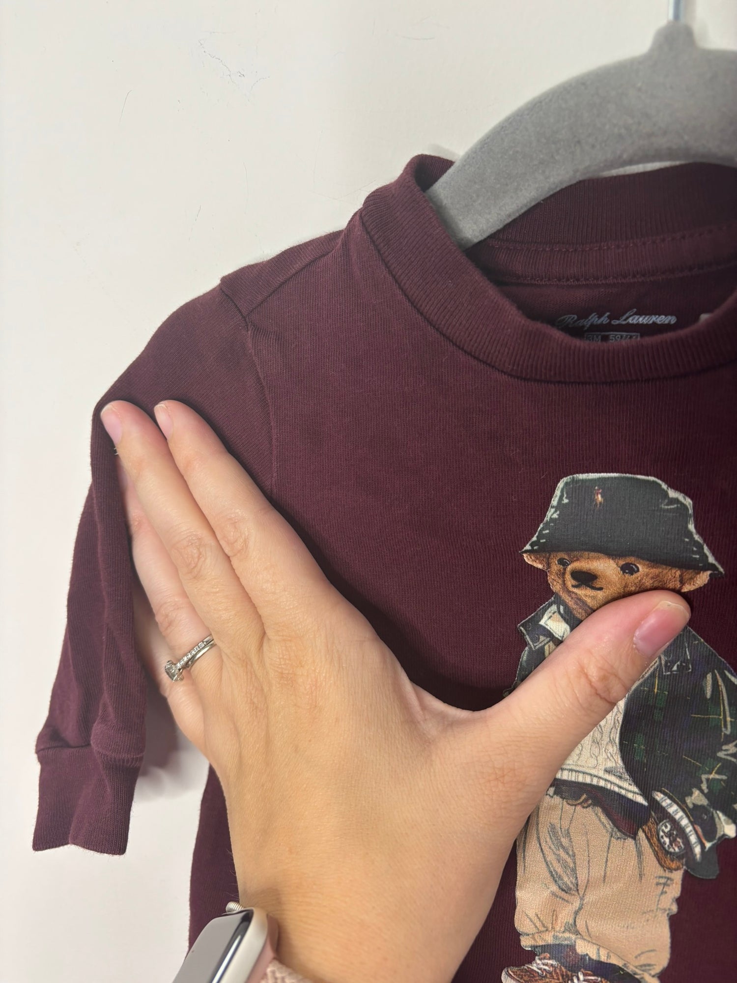 Brown Ralph Lauren Polo Bear sweatshirt featuring the classic bear in a preppy outfit, displayed on a hanger.