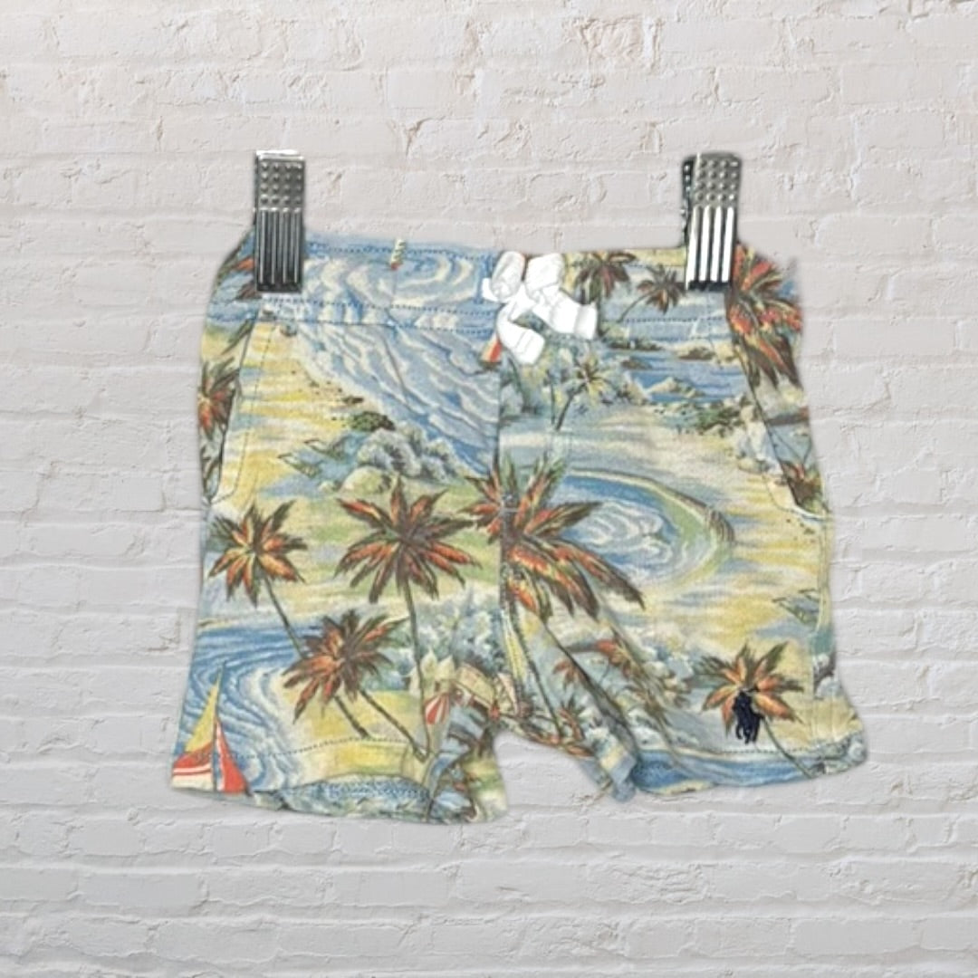 Multicoloured short-sleeve shirt and shorts set with tropical palm tree and sailboat print.