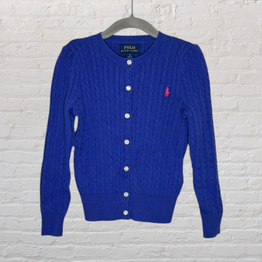 Blue cable knit cardigan with buttons and pink Polo Ralph Lauren logo, hanging on a hanger.
