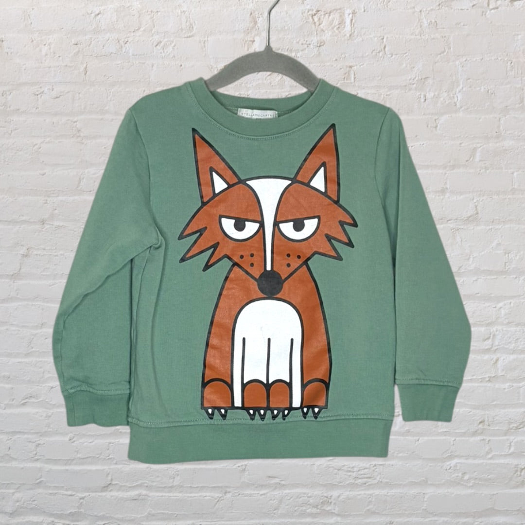 Green sweatshirt with a large fox graphic on the front, displayed on a hanger.