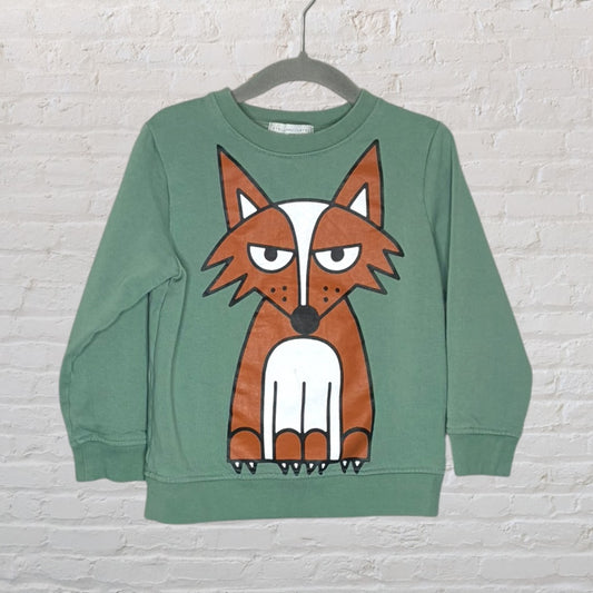 Green sweatshirt with a large fox graphic on the front, displayed on a hanger.