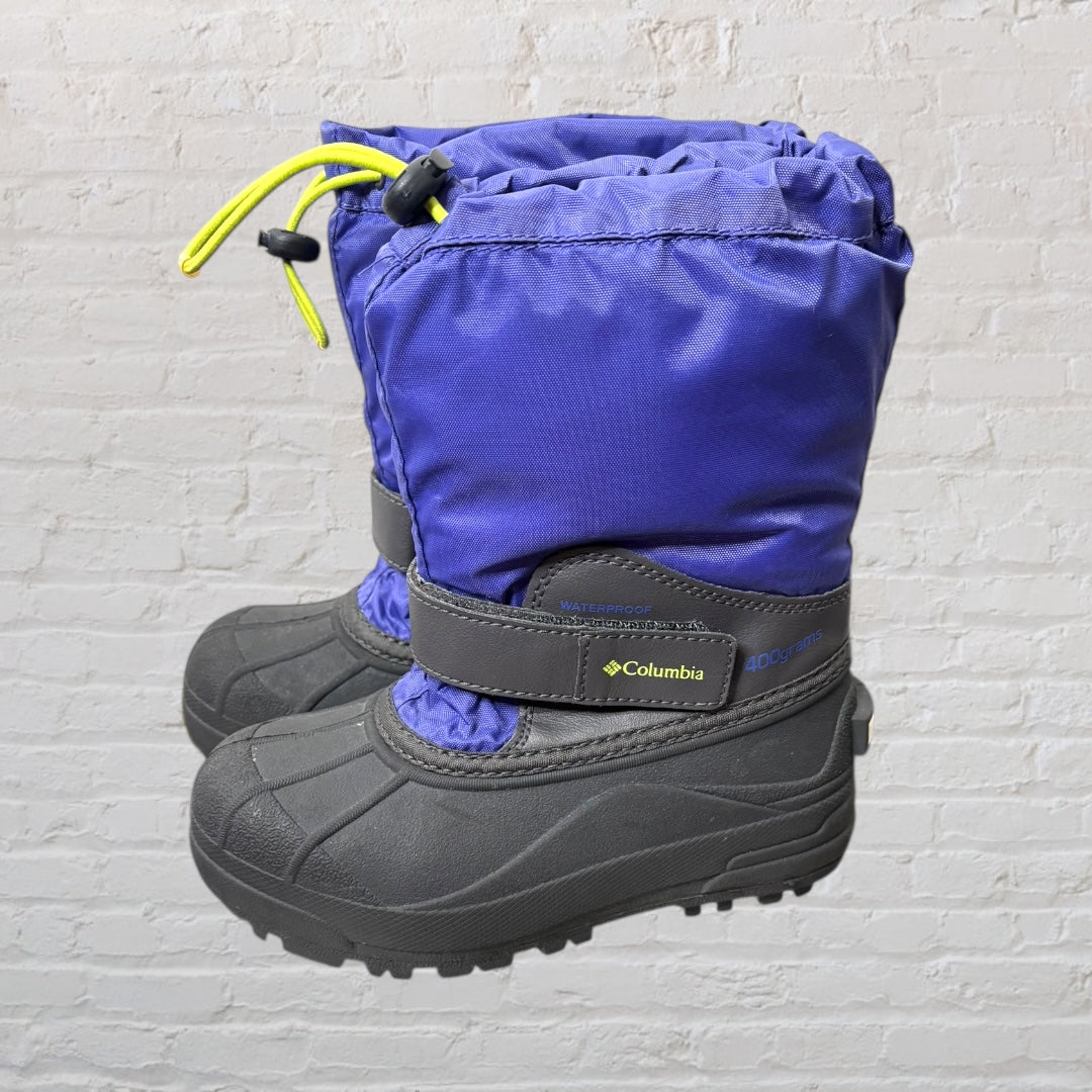 Columbia waterproof winter boots in purple and black with yellow drawcords, featuring a durable sole and warm lining.